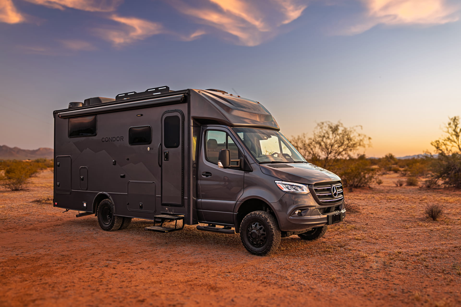 Entegra Coach Class C motorhome in desert canyon at sunset