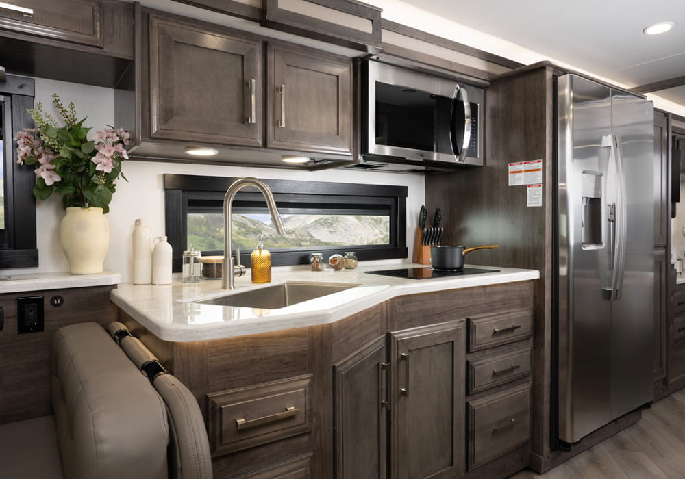 Entegra Coach Emblem kitchen with cabinetry and appliances