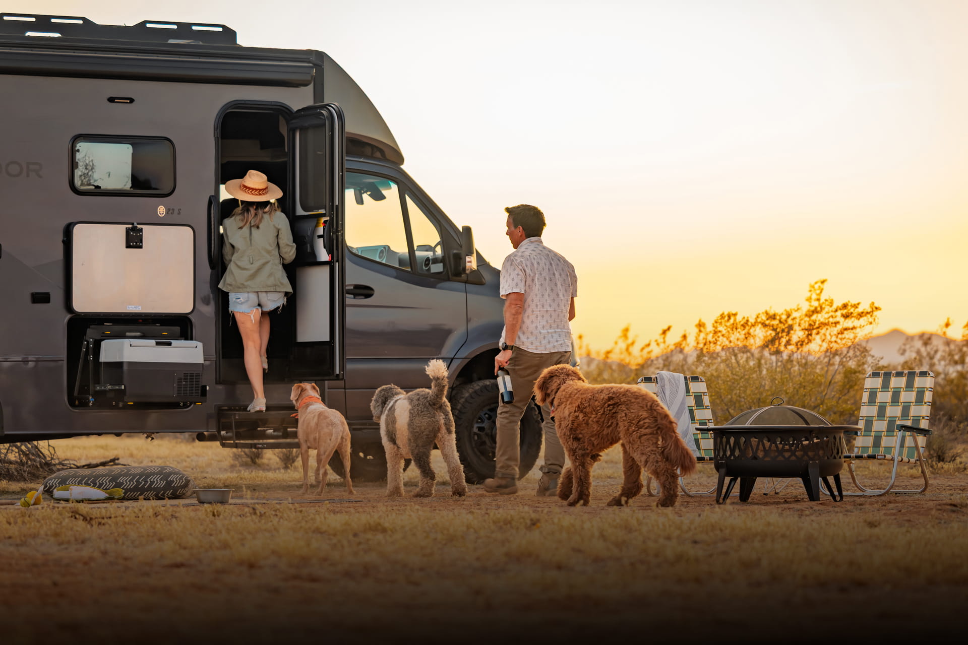 Entegra Coach Class C campsite at sunset with owners and dog