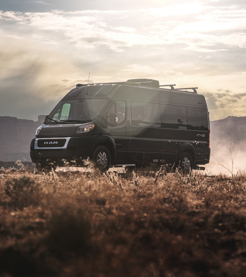 Entegra Coach Class B camper van on dirt road in desert dust