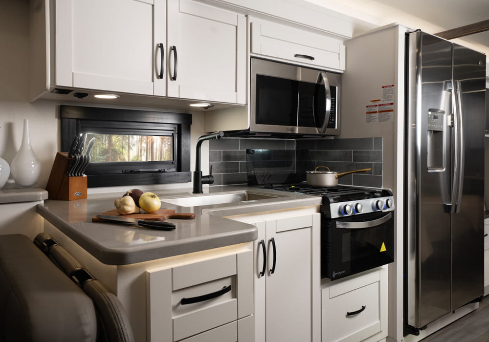 Entegra Coach Vision XL kitchen with cabinetry and refrigerator