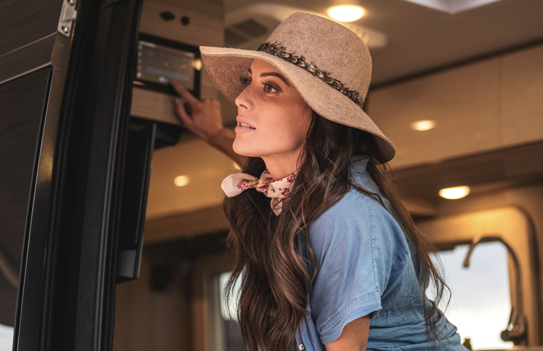Entegra Coach owner reaching into overhead cabinet