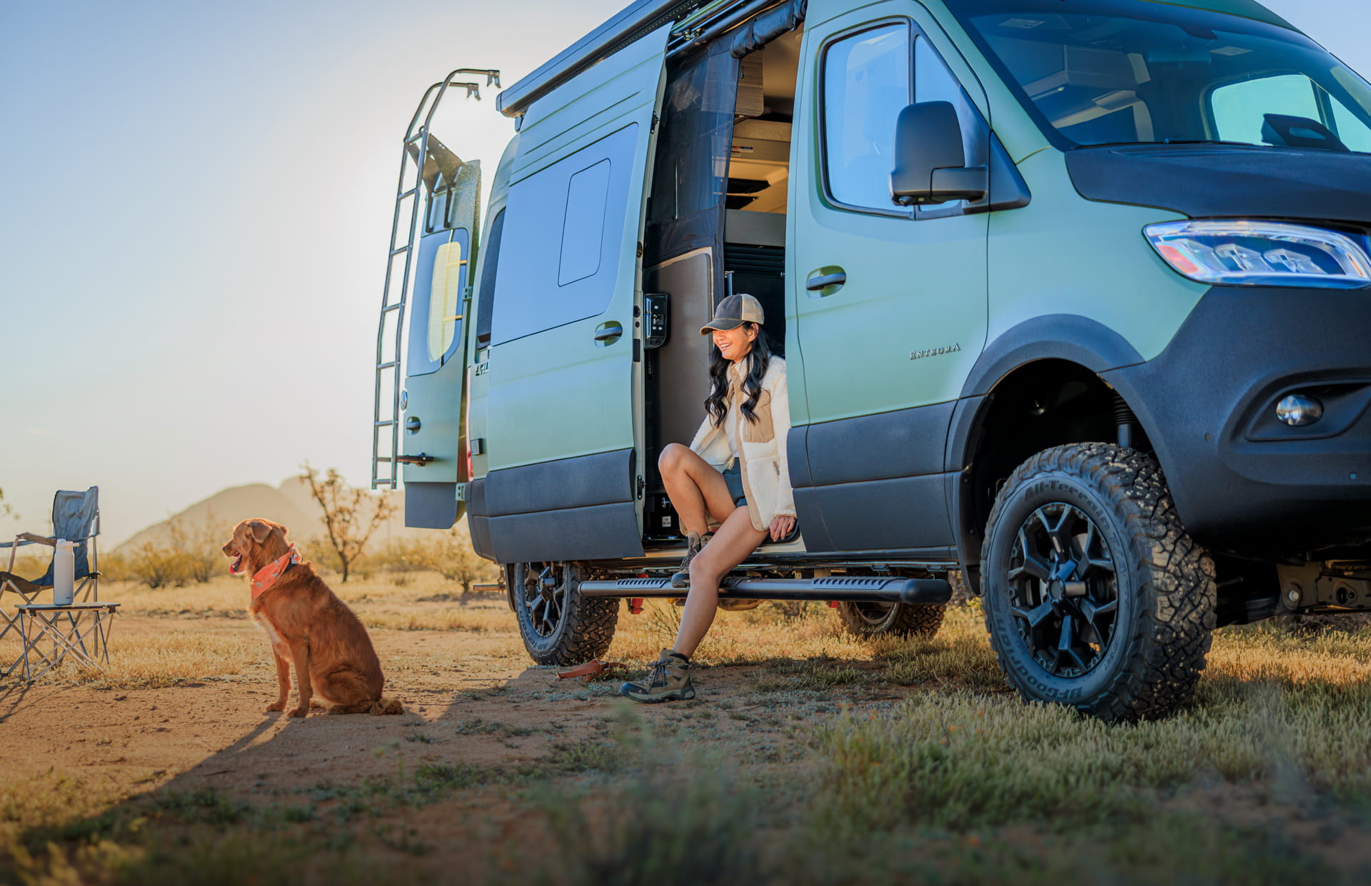 Entegra Coach Class B camper van with owner and dog at campsite