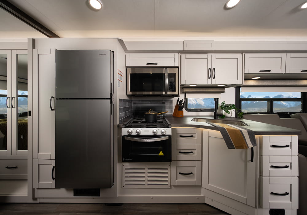 Entegra Coach Vision kitchen with refrigerator and cabinetry