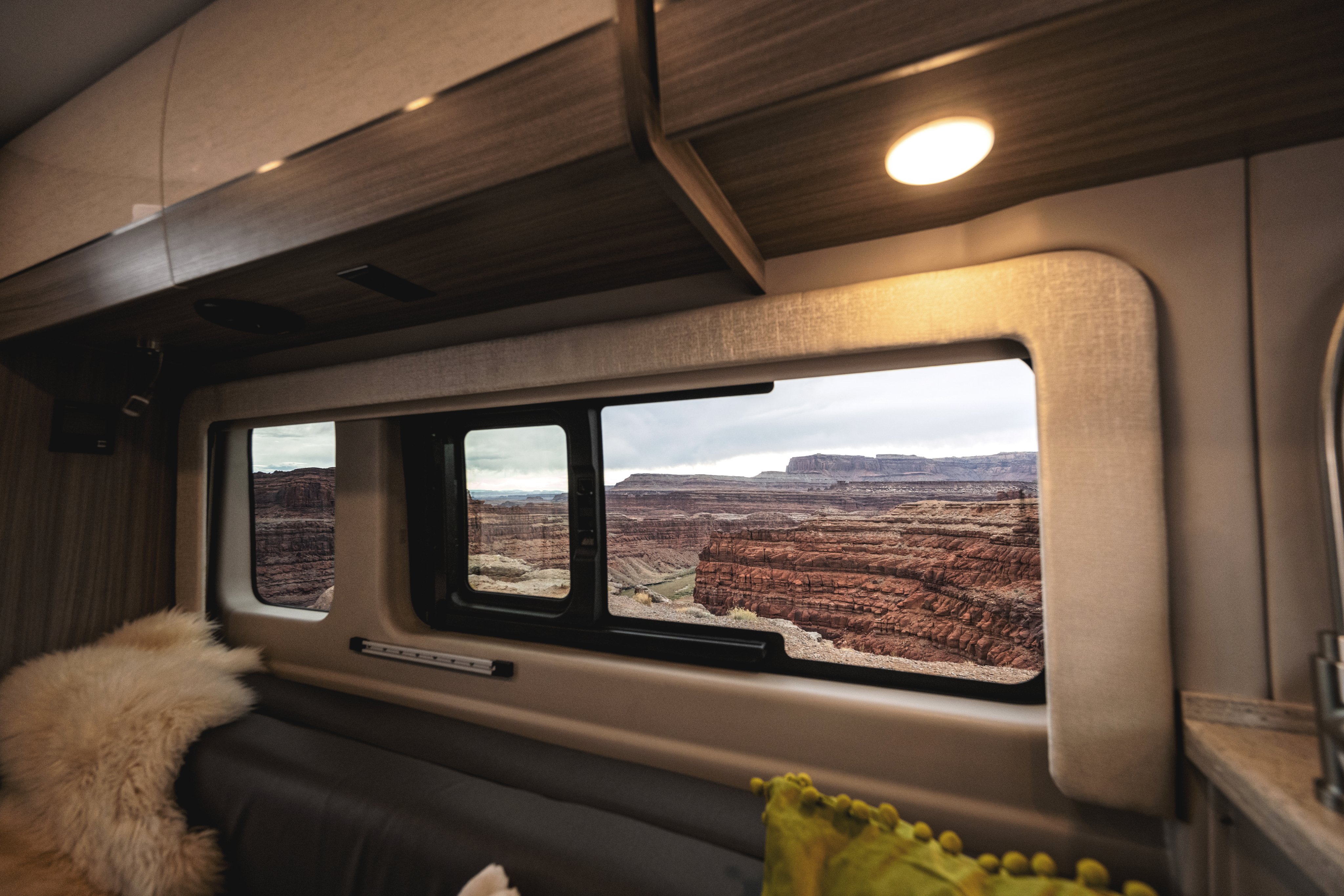 Entegra Coach interior with window view of canyon landscape and overhead galley
