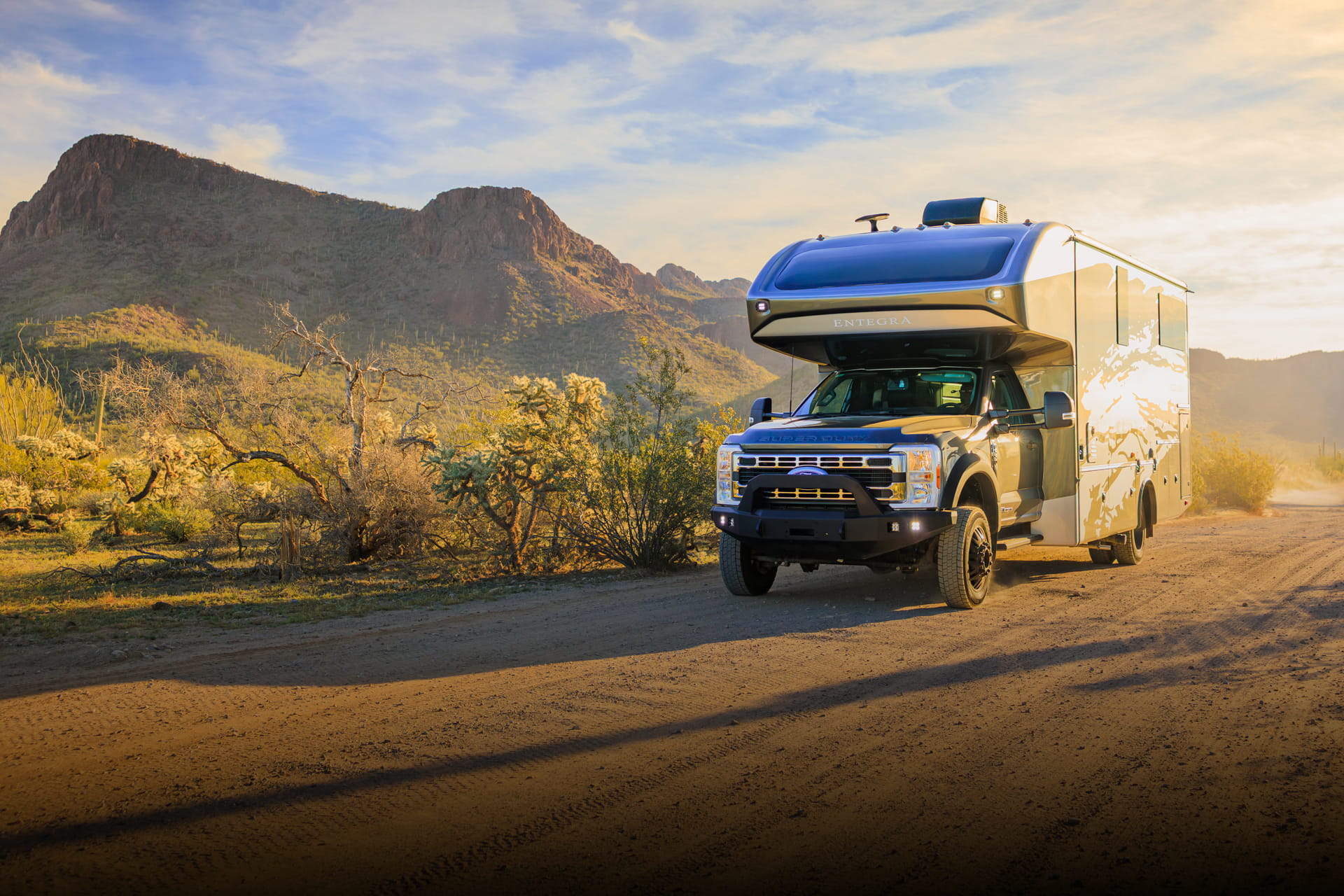 Entegra Coach Super C motorhome in desert with mountain backdrop